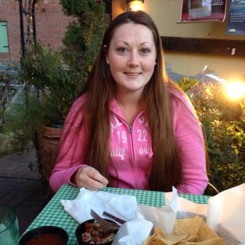 El Jardin - Amy sitting on the patio with the historic Columbia behind her. - Mexican Near Me - Columbia, California