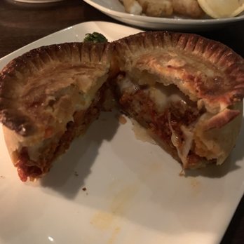 The Magnet - Inside of meat pie (beef and pork bolognese special) plus half eaten fried squid plate in the back - Beer Bar Near Me - Vancouver, British Columbia