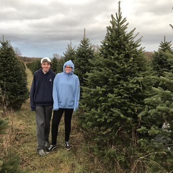 Hampton Hills Tree Farm - two people standing in front of a christmas tree - Landscaping Near Me - Dennison, Minnesota Hampton Hills Tree Farm - two people standing in front of a christmas tree - Landscaping Near Me - Dennison, Minnesota