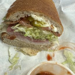 Club supreme on wheat, bread carved out &.relish on side