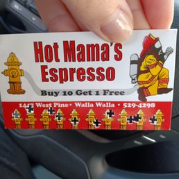 a hand holding a hot mama's espresso sticker
