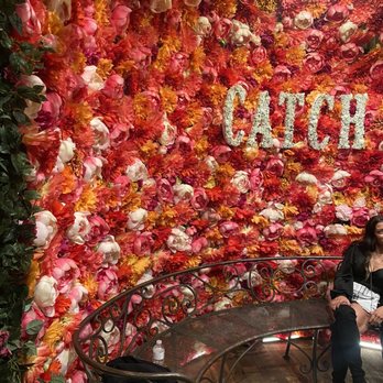 Catch - Flower wall (minus random lady taking a picture) - Seafood Near Me - Las Vegas, Nevada
