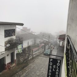 Hotel Posada El Volador - View from a communal outdoor balcony when the town was enveloped by clouds. This pic was taken one day after the other one.