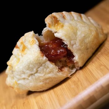 Girl From Empanada - a half eaten pastry - Empanadas Near Me - Park Ridge, New Jersey