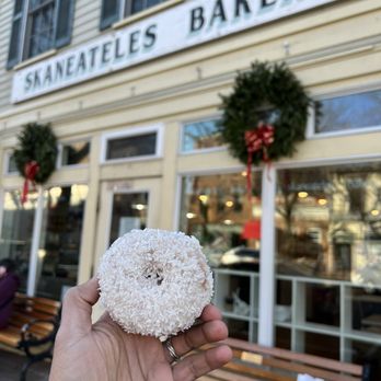 Skaneateles Bakery - a hand holding a doughnut - Bakeries Near Me - Skaneateles, New York Skaneateles Bakery - a hand holding a doughnut - Bakeries Near Me - Skaneateles, New York