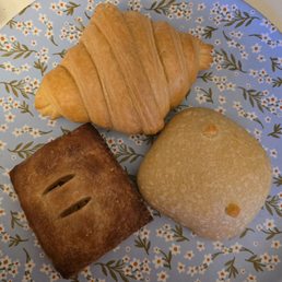 Croissant, peach handpie [bottom left], sausage egg and cheese sourdough roll [bottom right]