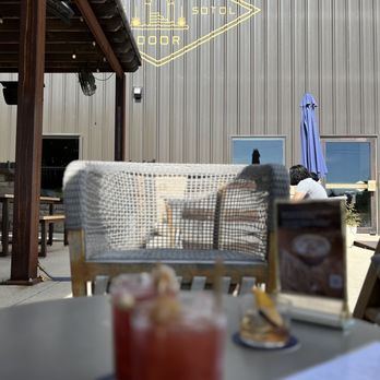 Desert Door - a table with drinks and a laptop - Distilleries Near Me - Driftwood, Texas Desert Door - a table with drinks and a laptop - Distilleries Near Me - Driftwood, Texas