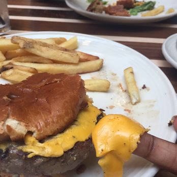 Blue Moon Taphouse - Burger with government yellow cheese that peels off the burger like old paint - Breweries Near Me - Norfolk, Virginia