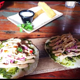 Shrimp and pineapple tacos with polenta chips and blue cheese sauce in the background. Shrimp and pineapple tacos with polenta chips and blue cheese sauce in the background.