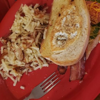 Windhill Pancake Parlor - Egg in a hole - A breakfast plate features egg in a hole on toasted bread, alongside pasta with cheese and bacon strips, on a red dish. - Breakfast & Brunch Near Me - McHenry, Illinois
