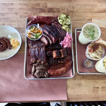 Interstellar BBQ - Lamb, beef, & Polish sausage, tomato zucchini salad, pork ribs, pulled lamb, brisket, pork belly, creamed corn, scallop potato, 4 cheese mac - Barbeque Near Me - Austin, Texas Interstellar BBQ - Lamb, beef, & Polish sausage, tomato zucchini salad, pork ribs, pulled lamb, brisket, pork belly, creamed corn, scallop potato, 4 cheese mac - Barbeque Near Me - Austin, Texas