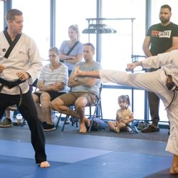 Jin Martial Arts - One of our high belts does a drill with master Jeff on test day. Executing a side kick followed by a roundhouse kick.