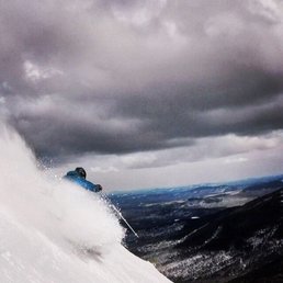 a person skiing down a mountain a person skiing down a mountain
