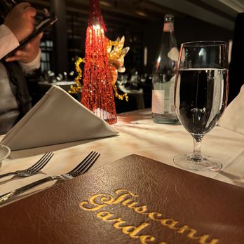 Bistecca - a table setting with a menu and a glass of wine - Italian Near Me - Las Vegas, Nevada