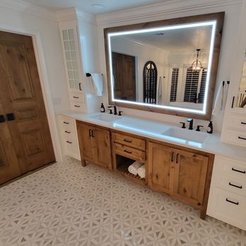 JTG Construction - a bathroom with a large mirror - General Contractors Near Me