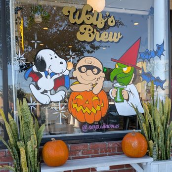 Wolf's Brew Coffee - Snoopy and Charlie Brown on the glass window for Halloween. - Coffee & Tea Near Me - Long Beach, California