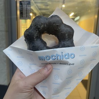 Mochido - a hand holding a donut in a paper bag - Desserts Near Me - Coquitlam, British Columbia Mochido - a hand holding a donut in a paper bag - Desserts Near Me - Coquitlam, British Columbia