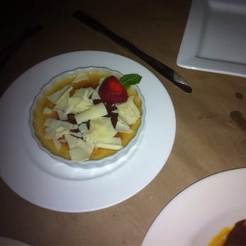 Si Tapas - Creme Broulet with white chocolate shavings. - Spanish Near Me - Dallas, Texas Si Tapas - Creme Broulet with white chocolate shavings. - Spanish Near Me - Dallas, Texas