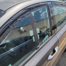 Windows duct-taped shut due to faulty window regulators.
