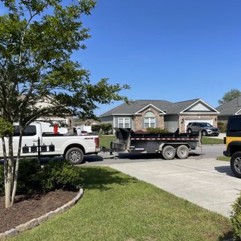 USA Landscaping - a truck and a truck parked in front of a house - Lawn Services Near Me USA Landscaping - a truck and a truck parked in front of a house - Lawn Services Near Me