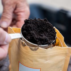 Revival Gardening - Organic worm castings being measured out of the bag.