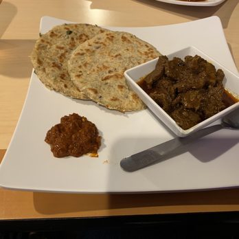 Spicy Zest - Restaurant & Bar - Coconut Rotti (2) with spicy chili onion chutney (lunumiris) and spicy beef curry (level 5) - Sri Lankan Near Me - Farmers Branch, Texas Spicy Zest - Restaurant & Bar - Coconut Rotti (2) with spicy chili onion chutney (lunumiris) and spicy beef curry (level 5) - Sri Lankan Near Me - Farmers Branch, Texas