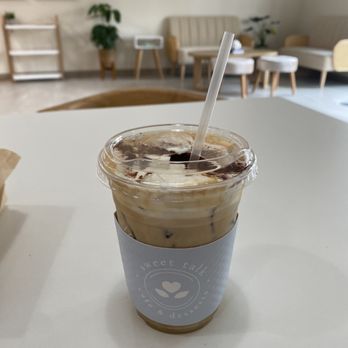 Sweet Talk Cafe - The Sweet Talk Latte. Iced hazelnut cream Einspanner (espresso topped with whipped cream) with white chocolate drizzle. - Cafes Near Me - Apex, North Carolina