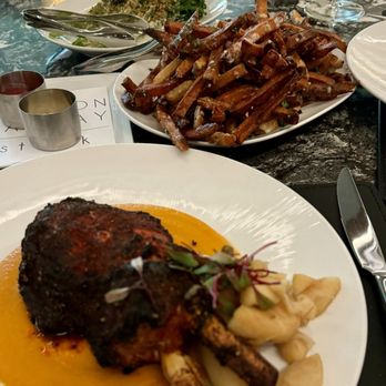 Gordon Ramsay Steak - Pork chop entree, truffle fries and broccolini - Steakhouses Near Me - Elizabeth, Indiana Gordon Ramsay Steak - Pork chop entree, truffle fries and broccolini - Steakhouses Near Me - Elizabeth, Indiana