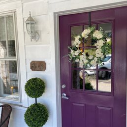 a purple front door with a wreath