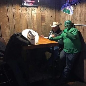 Waterhole Saloon - two men sitting at a table - Bars Near Me - Stanford, Montana