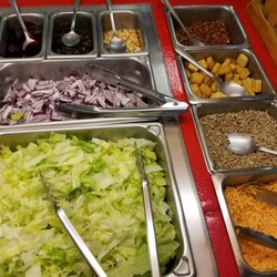 Brian's Deli - From bottom left to right: Head Lettuce, Shredded Cheese, Sunflower Seeds, Onions, Croutons, Beets, Black Olives, Peanuts, Bacon.