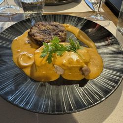 Pork dish with a mushroom and onion cake
