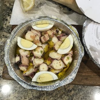 Allegro Seafood Grill - a pan of sliced octopus and sliced eggs - Portuguese Near Me - Newark, New Jersey