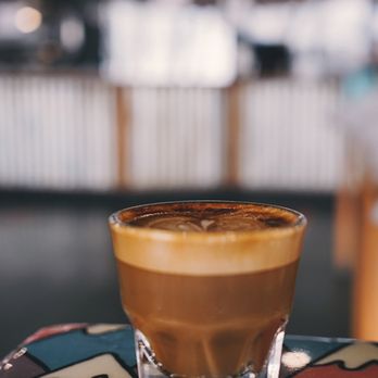 Bongo East + GamePoint - a glass of coffee on a table - Coffee & Tea Near Me - Nashville, Tennessee