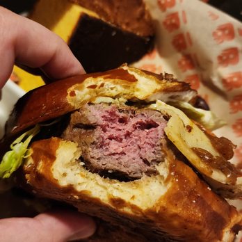 Burgatory - Fox Chapel - a hand holding a sandwich - Burgers Near Me - Pittsburgh, Pennsylvania Burgatory - Fox Chapel - a hand holding a sandwich - Burgers Near Me - Pittsburgh, Pennsylvania