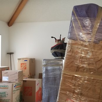 Suburban Relocation Systems - Furniture wrapped and staged for loading by the movers. Boxes packed by us. Table with legs up is the one that got trashed. - Movers Near Me - Commerce City, Colorado