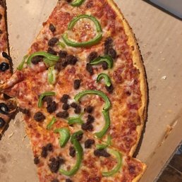 a half eaten pizza with olives and peppers a half eaten pizza with olives and peppers