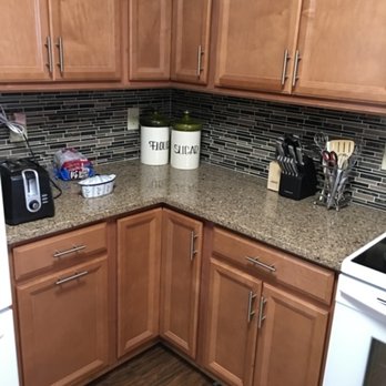 JLC Construction - a kitchen with wood cabinets and white appliances - General Contractors Near Me JLC Construction - a kitchen with wood cabinets and white appliances - General Contractors Near Me