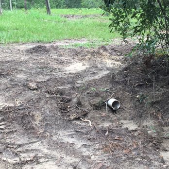 Sun Coast Septic and Drains - Outflow pipe surrounded by very uneven dirt. - Septic Services Near Me - Kiln, Mississippi