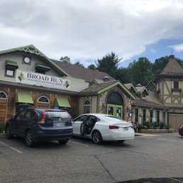  two cars parked in front of a restaurant