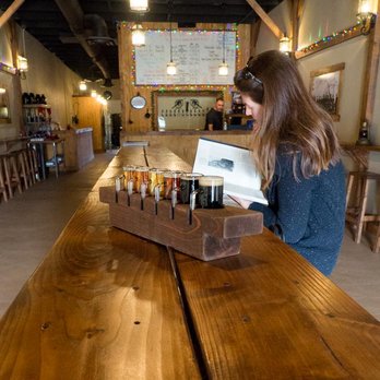 Smoking Cannon Brewery - a woman sitting at a long wooden table - Breweries Near Me - Ramona, California Smoking Cannon Brewery - a woman sitting at a long wooden table - Breweries Near Me - Ramona, California