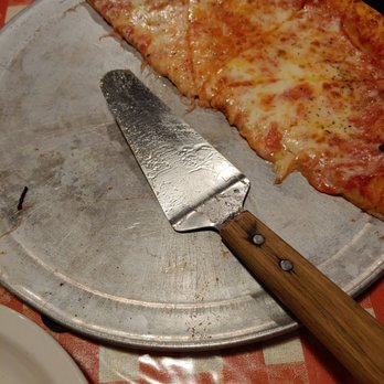 Ikey's Pizzeria - a slice of pizza on a pizza pan - Pizza Near Me - Gladstone, Missouri