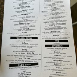 Menu 2023 - A printed menu from a cafe offers a variety of sandwiches, salads, quinoa bowls, soups, and breakfast items, with detailed descriptions of each dish.