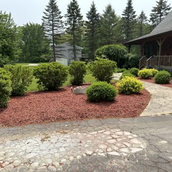 Lawn Critters - a gravel path in front of a house - Lawn Services Near Me