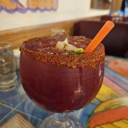 Las Chavelas - Huckleberry margarita on the rocks with chamoy and tajin.$12