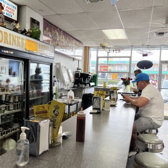 El Rey De Las Fritas - a man sitting at a counter - Cuban Near Me - Hialeah, Florida