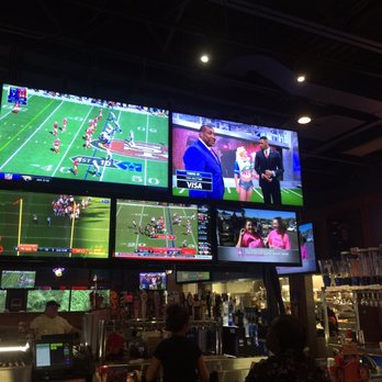 Kickback Jack's - Other side of bar TVs - American Near Me - Greenville, North Carolina Kickback Jack's - Other side of bar TVs - American Near Me - Greenville, North Carolina