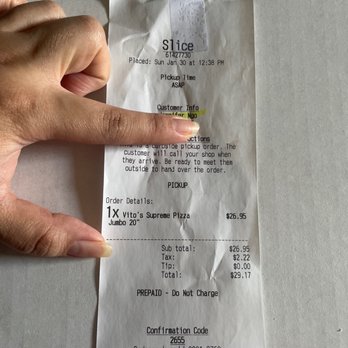 Vito's Pizza & Grill - a person's hand holding a receipt - Pizza Near Me - Irving, Texas