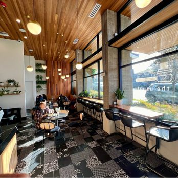 The Usual - View looking toward the back, bathroom behind seating at left, tables in middle, countertop seating at right at large street-facing windows - Coffee & Tea Near Me - Seattle, Washington The Usual - View looking toward the back, bathroom behind seating at left, tables in middle, countertop seating at right at large street-facing windows - Coffee & Tea Near Me - Seattle, Washington