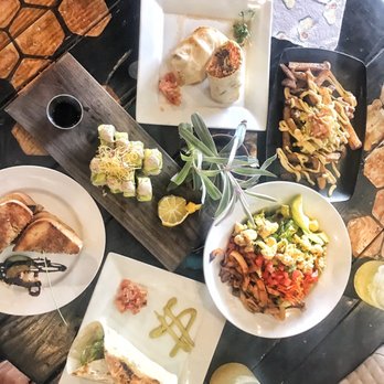 Moku Roots - Food (counterclockwise): sushi roll of the day, portabello grilled cheese, falafel wrap, cobb salad, loaded fries, buffalo cauliflower wrap - Vegan Near Me - Kula, Hawaii